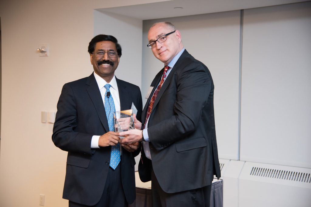 Jonathan Hill presents the Leadership and Service in Technology award to Suresh Kumar