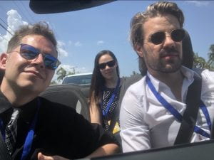 The photo itself is a selfie of three people in a car.